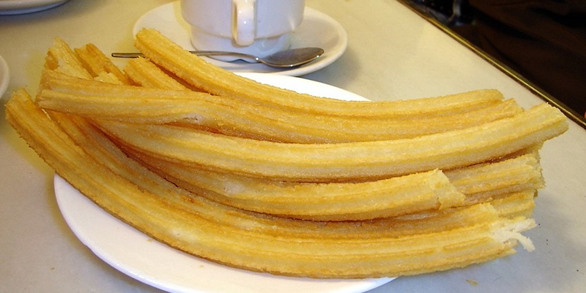 Warm up with churros and rich hot chocolate at San Gines, a cozy November treat in Madrid.