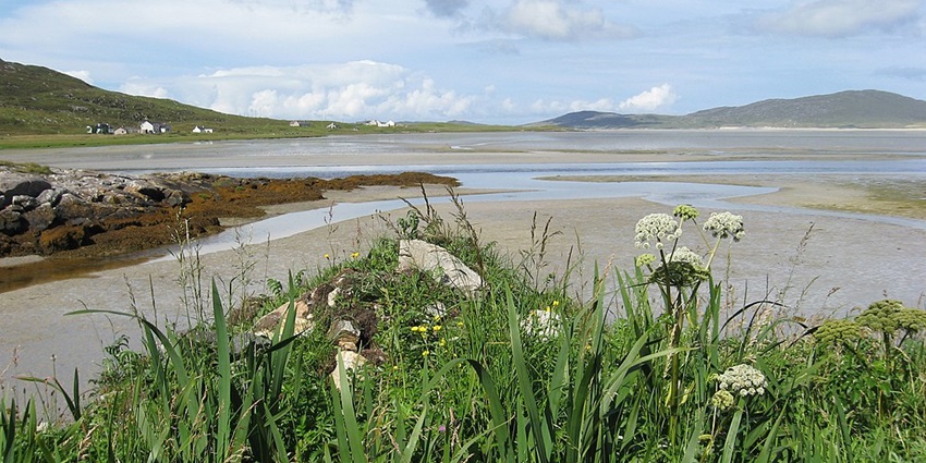 View of a scenic Hebridean beach with pristine white sands and turquoise waters.