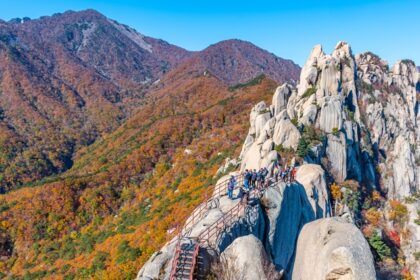 Seoraksan National Park features statues, breathtaking landscapes, hiking trails, and temples.