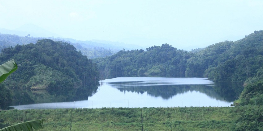Serlui B Lake with the Serlui B dam and still water body surrounded by dense green hills