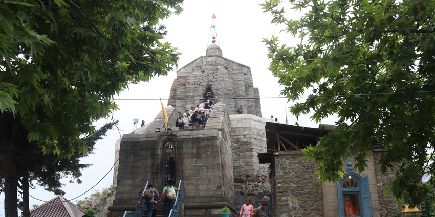 Shankaracharya temple with devotees climbing up the stairs admiring traditional architecture