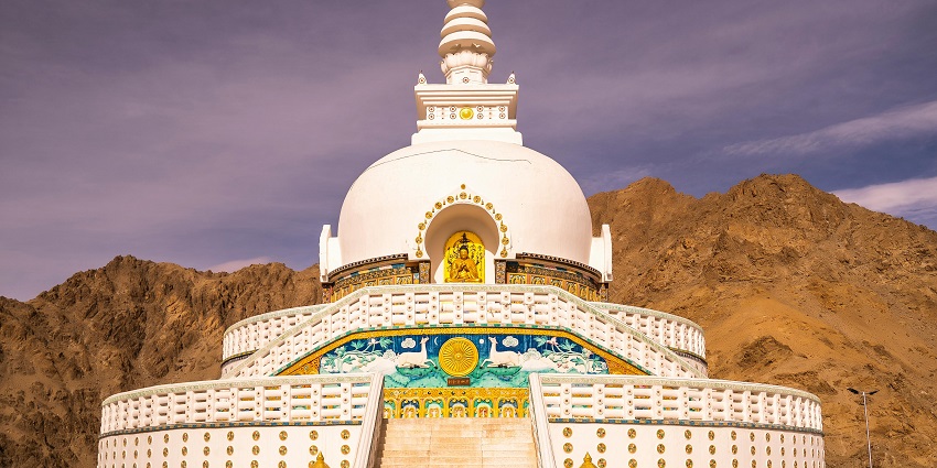 A Buddha Idol and painting at Shanti Stupa, a place to visit after paragliding in Leh