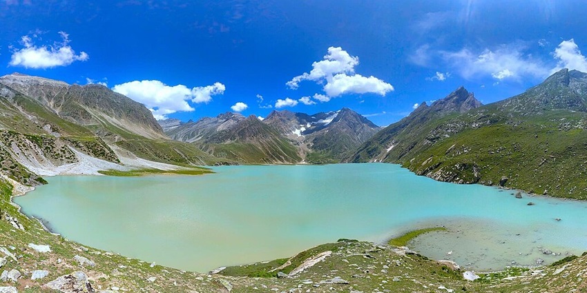 Sheshnag Lake with bright, clear cyan water surrounded by green mountains - Famous Lakes In Jammu And Kashmir