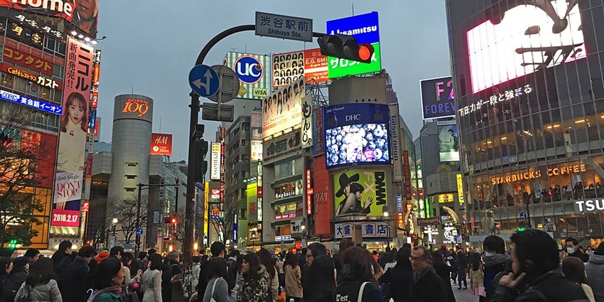 Shibuya Scramble, a bustling place for night in Tokyo, packed with pedestrians and neon signs