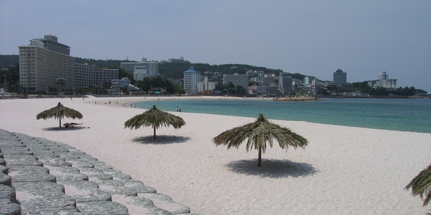 Popular white sand beach with clear waters and resorts.