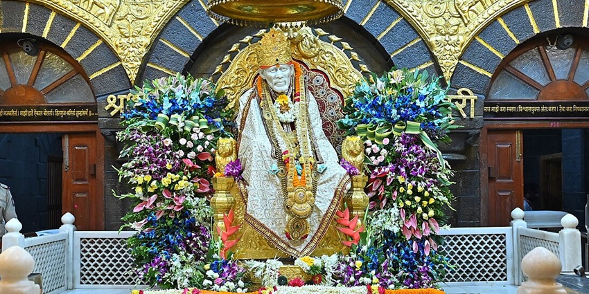 White marble tomb and seated Sai Baba idol inside Shirdi’s Samadhi Mandir