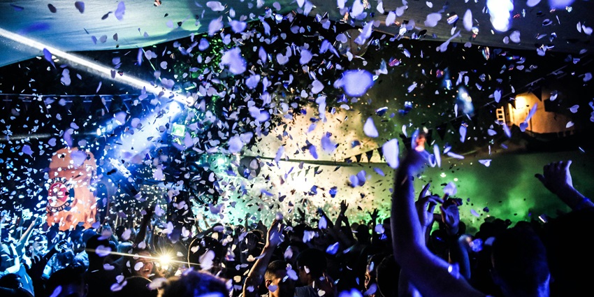 People dancing to energetic beats in Madrid Nightlife clubs.
