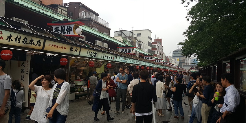 Bustling shopping street offering traditional souvenirs and snacks.