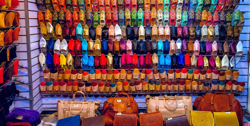 A view of assorted colourful women's flats hanging in a store in the handicraft market.