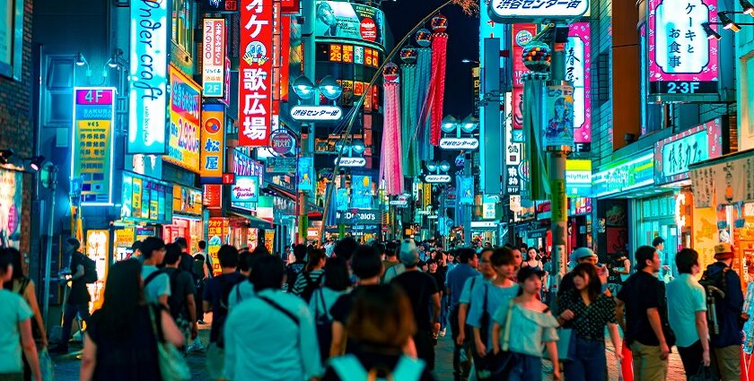 An image of a crowd roaming around at night in a shopping street complex resembling seoul