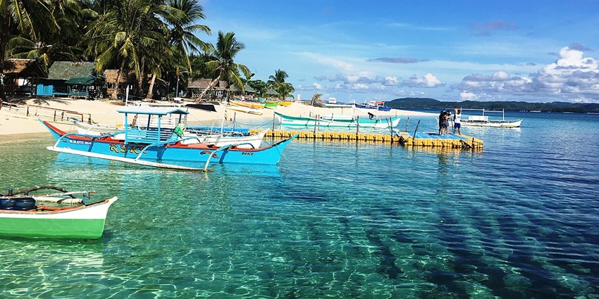 Surfing hotspot famous for Cloud 9 waves and island charm