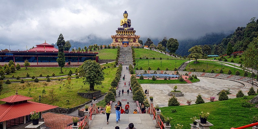 An image showing Ravangla Buddha Park in Sikkim featuring a large Buddha statue and open space