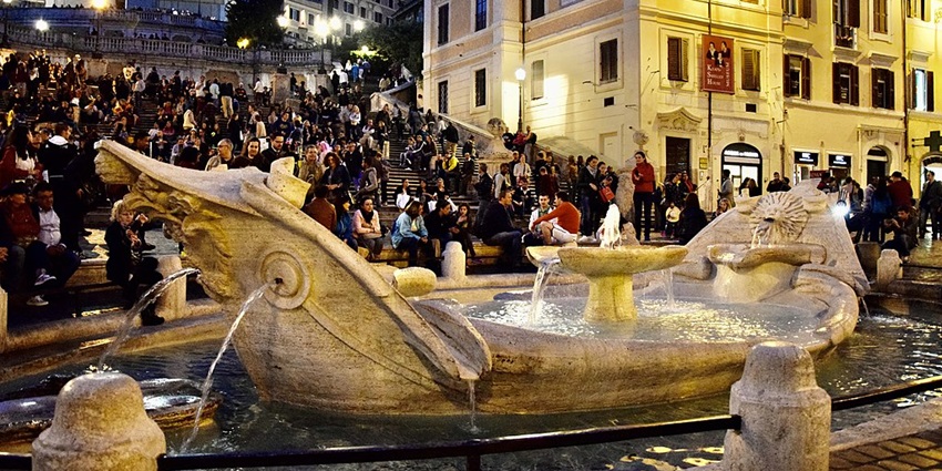 Tourists watching the fountains at the Spanish Steps, a relaxing thing to do in Rome.