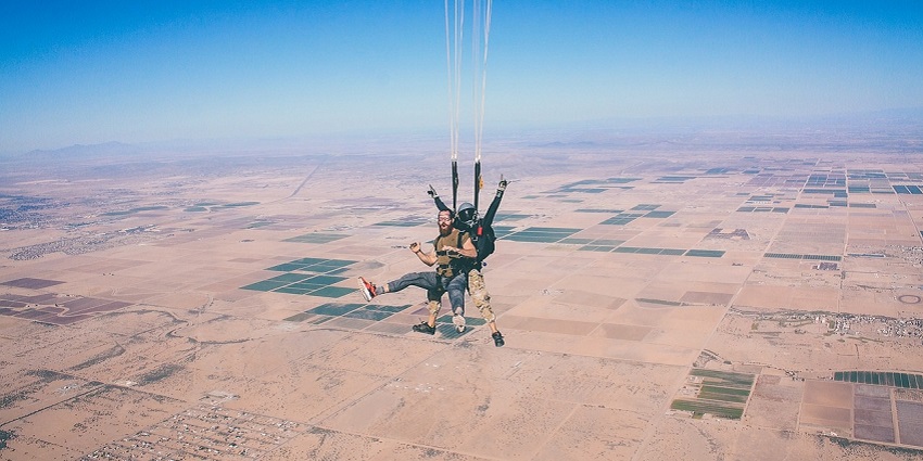 An image showing skydiving with a parachute, capturing the thrill of extreme adventure.
