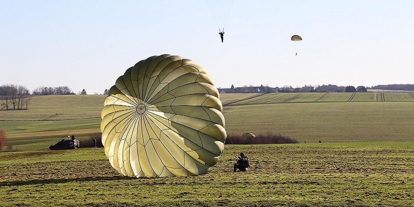An image showing a skydiver soaring over nature reflecting skydiving in Germany.