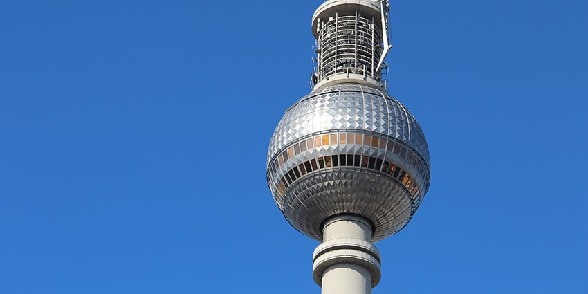 An image showing the upper part of the Berlin TV Tower, highlighting its iconic design.