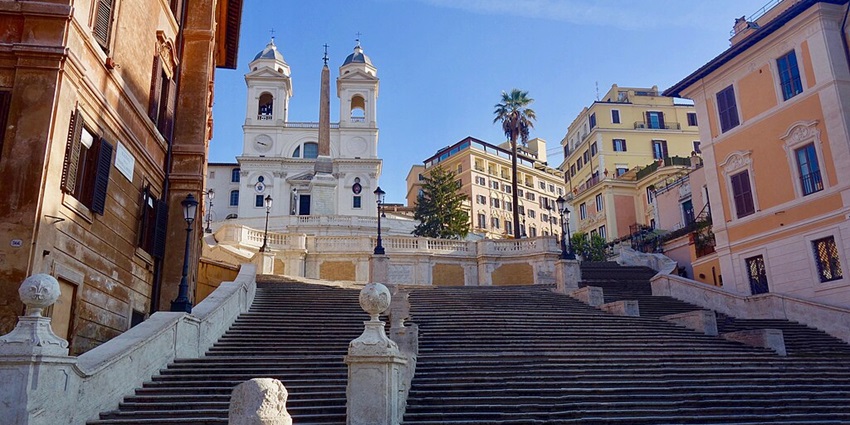 Both tourists and locals relaxing and people-watching on the Spanish Steps in Rome.