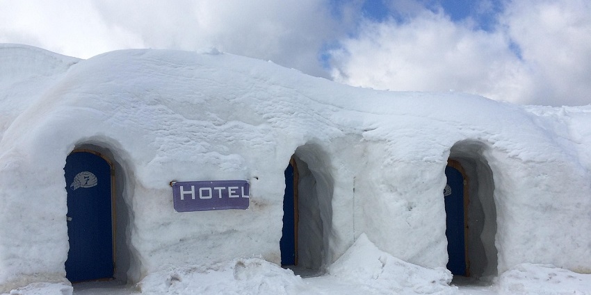 An image showing an ice hotel with igloos, offering a unique and chilly experience.