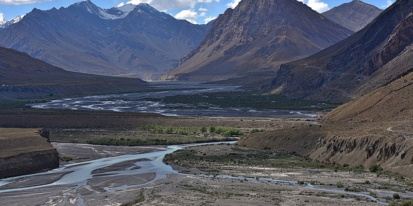 A couple enjoying a breathtaking view of the Spiti Valley landscapes.