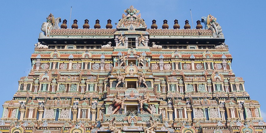 Gopuram of a temple with detailed architecture and colourful, vibrant, intricate carvings