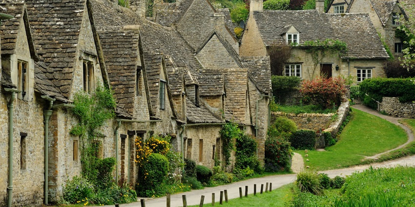Picturesque village of Bibury with stone cottages and lush scenery in UK