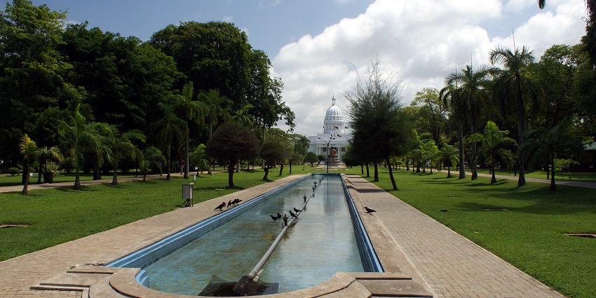 Viharamahadevi, a lush park with serene paths, fountains, and a view of the Town hall.