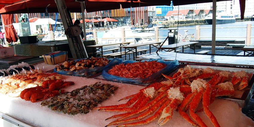 An Image of the Bergen Fish Market, where a marketplace with stalls of fish visible in the image.