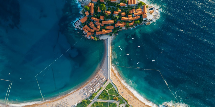 A picturesque beach with stunning views of the iconic islet of Sveti Stefan for travellers