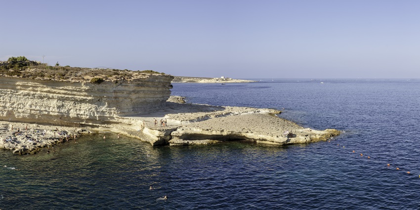 Swim in the crystal-clear waters of St. Peter’s Pool, a natural rock pool near Marsaxlokk.