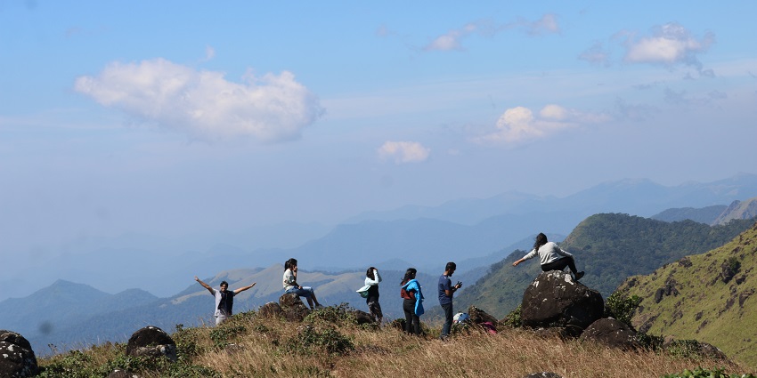 An image of Tadiandamol Trek with green slopes, misty peaks, and vast landscapes.