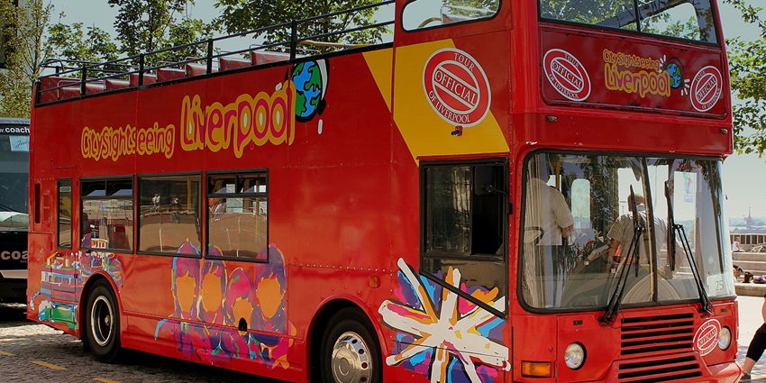Open-top bus passing iconic landmarks, offering stunning cityscape views