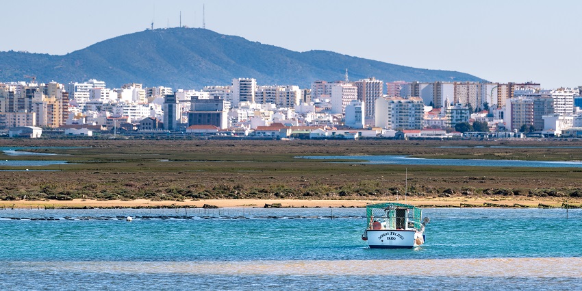 An image of a Boat sailing through the beautiful Ria Formosa Natural Park in Portugal