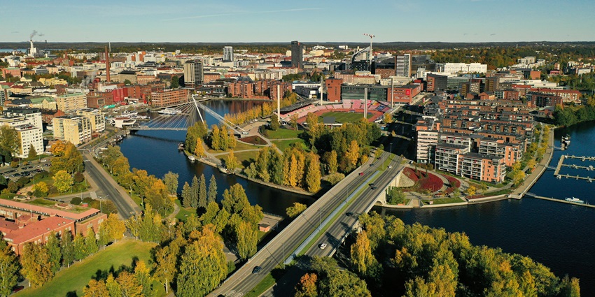 An image showing an aerial view of Tampere, highlighting its urban landscape and nature.