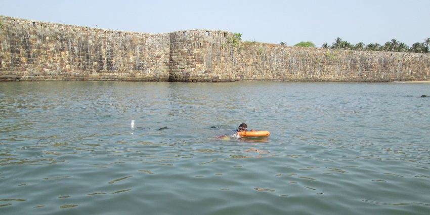 a person snorkelling in Tarkarli, near the fort, the best place for snorkelling in India