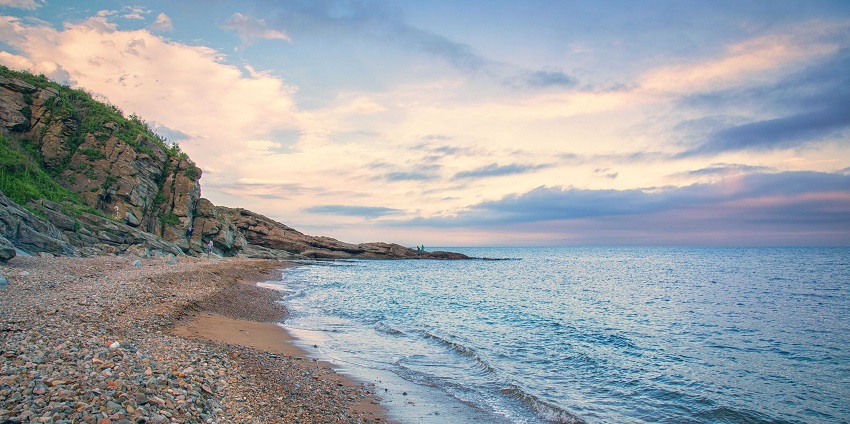 Secluded shoreline with soft sand and lush greenery, among the best beaches.