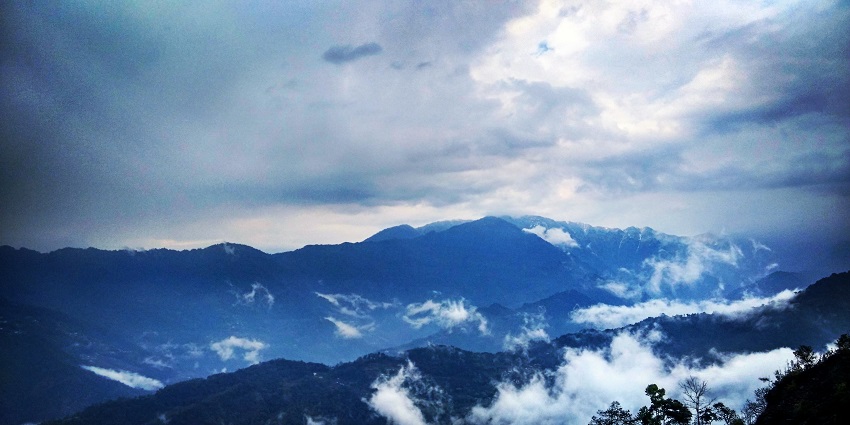 A scenic view of the majestic Himalayas covered with clouds from Tashi viewpoint Gangtok.