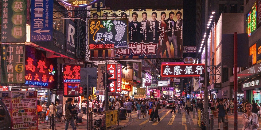 View of the Temple Street Night Market with shops having various souvenirs to buy.
