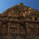 Majestic gopuram of a temple with detailed architecture and intricate statue carvings