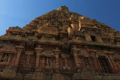 Majestic gopuram of a temple with detailed architecture and intricate statue carvings