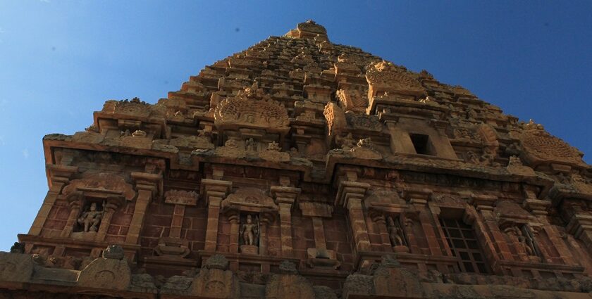 Majestic gopuram of a temple with detailed architecture and intricate statue carvings