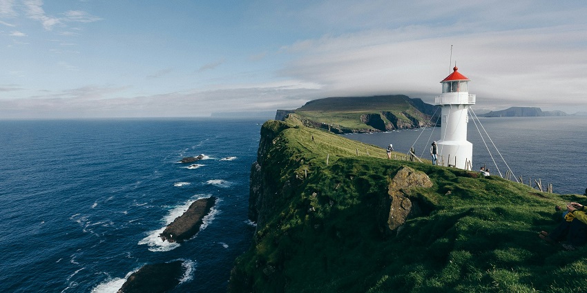Image of the Faroe Islands, with rugged cliffs, among the top places to visit in Denmark