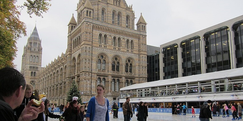 An image showing people ice skating outside the Natural History Museum, enjoying the winter season.