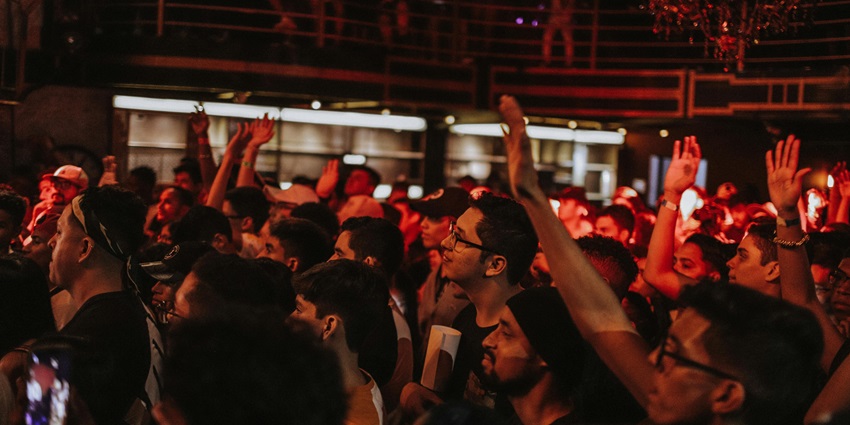 An image showing people dancing inside a bar, similar to the vibrant atmosphere of The Riff.