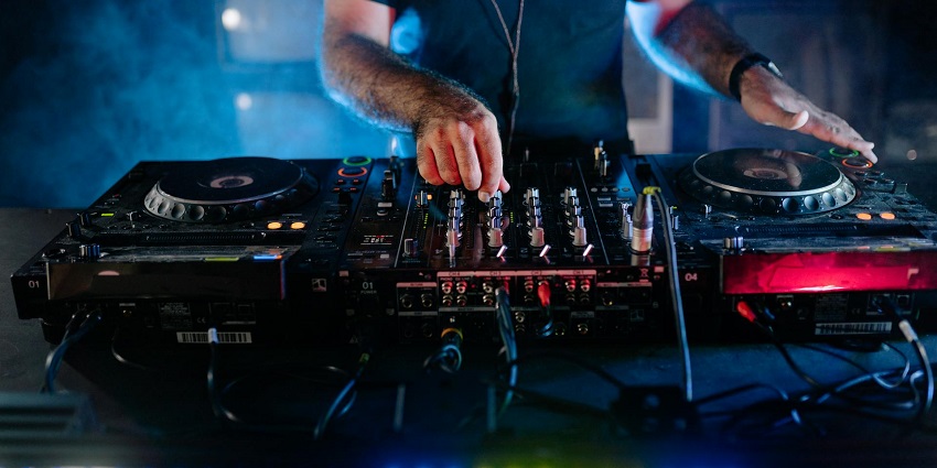An image of people celebrating and dancing, with music creating an electric atmosphere in the bar.