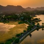 Sunset over the Fateh Sagar Lake, Udaipur with glittery water and the Aravalli range