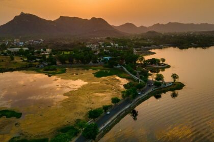 Sunset over the Fateh Sagar Lake, Udaipur with glittery water and the Aravalli range