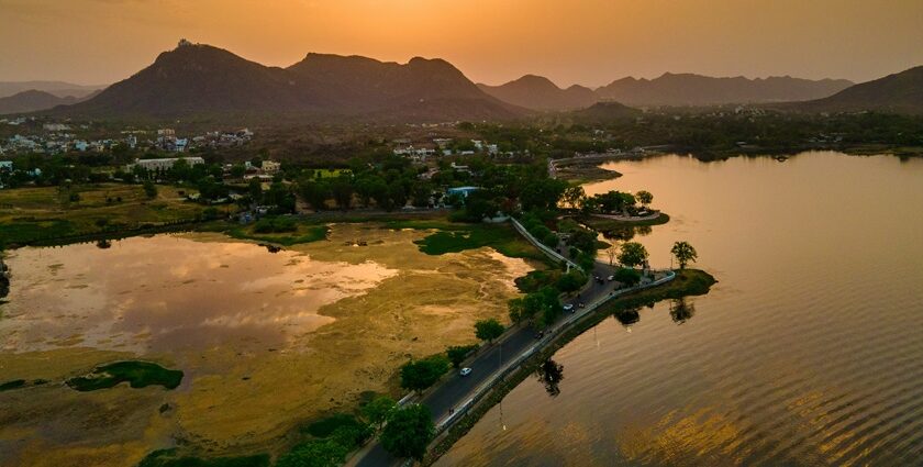 Sunset over the Fateh Sagar Lake, Udaipur with glittery water and the Aravalli range