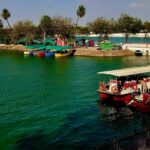 Boating in Kankaria Lake, while reflecting rays of the Sun creates a twilight glow