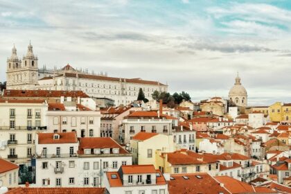 A Lisbon cityscape with red-tiled roofs and buildings, showcasing the charm of Portugal