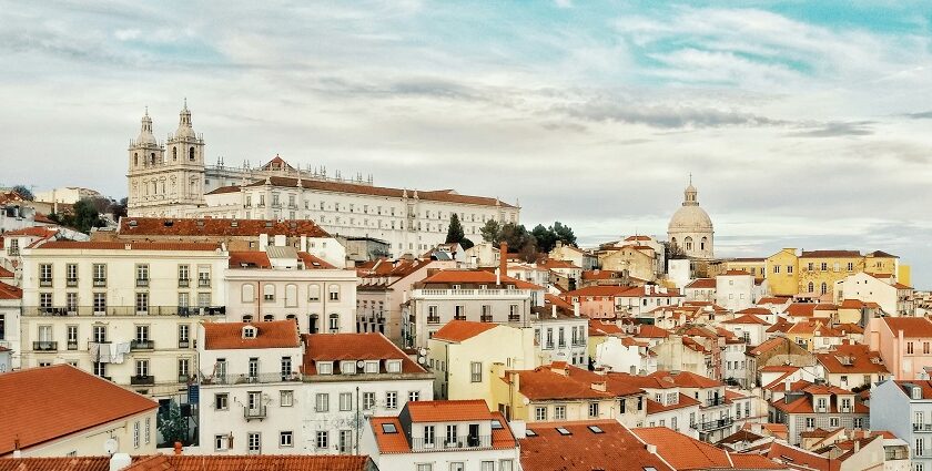 A Lisbon cityscape with red-tiled roofs and buildings, showcasing the charm of Portugal